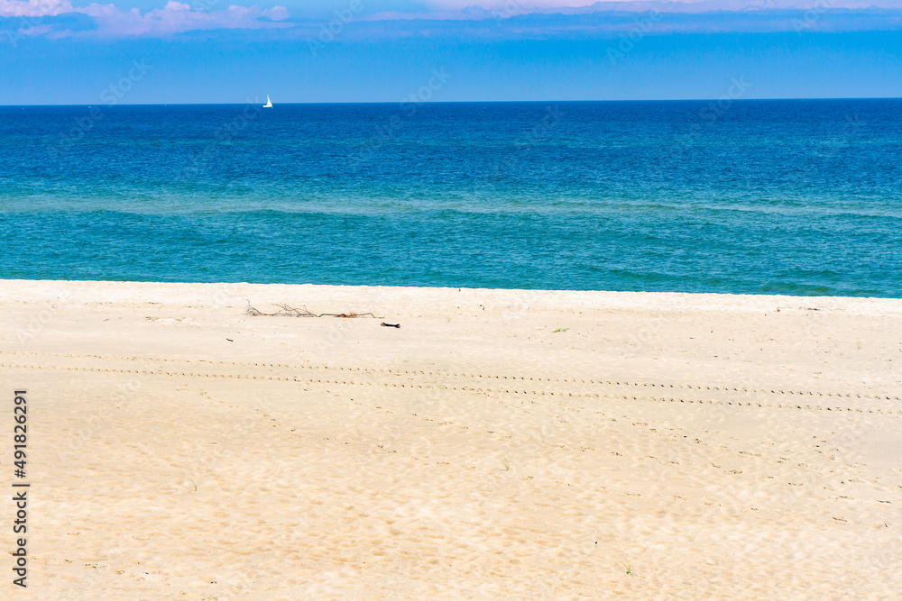 View of Baltic sea coast. Summer landscape. A lonely beach with white sand and blue sea. Hel, Hel Peninsula, Pomerania, Poland View of Baltic sea coast. Summer landscape. A lonely beach with white sand and blue sea. Hel, Hel Peninsula, Pomerania, Poland