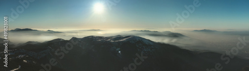 Mountains landscape with some clouds over them in winter © ardasavasciogullari