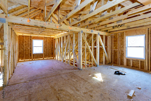 New stick built building view framing of beams on new home under construction