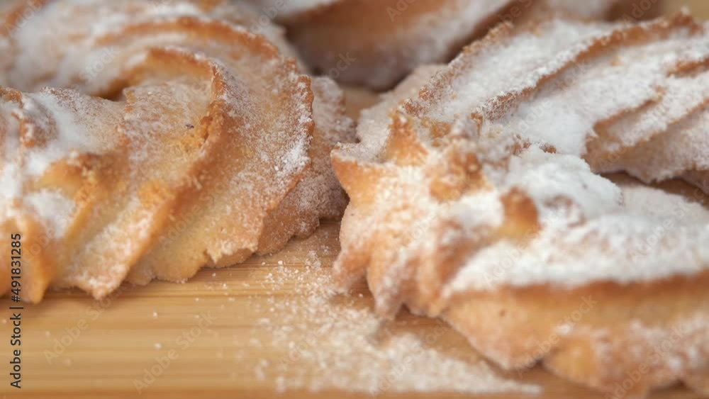 Fresh baked cookies is sprinkled powdered sugar. Shortbread dough baking. Bakery Fresh baked cookies is sprinkled powdered sugar. Shortbread dough baking. Bakery