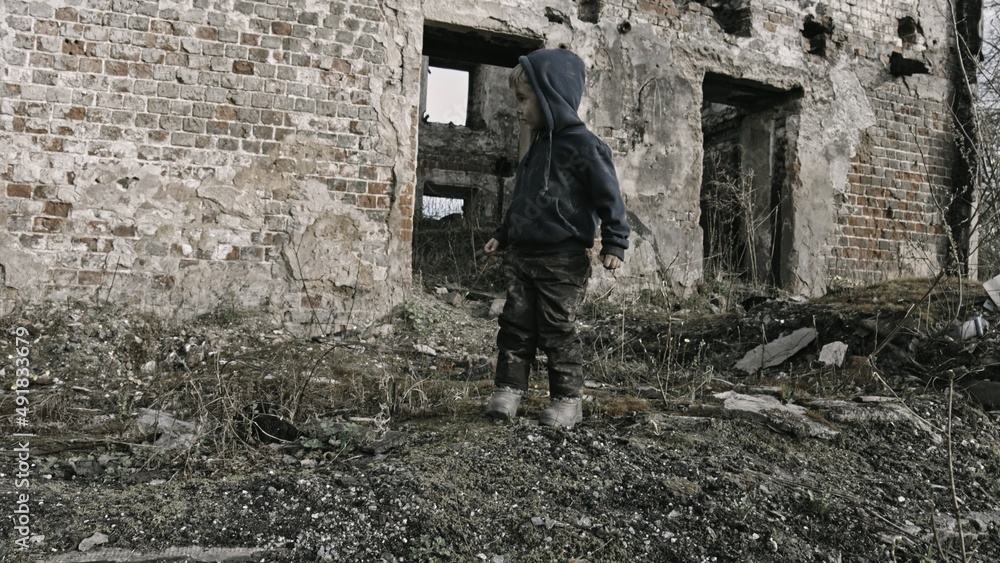Child playing war in ruins Child playing war in ruins
