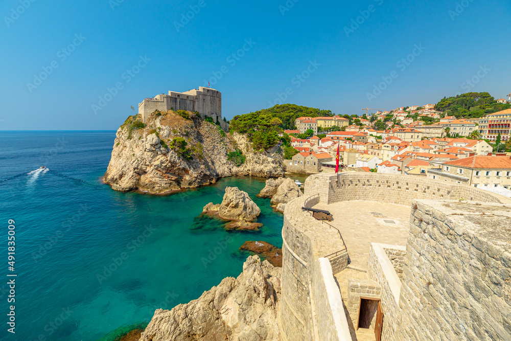 Aerial view on top walls of Dubrovnik city of Croatia. Looking Fort Lovrijenac fortress, over the West Harbour. Dubrovnik historic city of Croatia in Dalmatia. UNESCO World Heritage Site.
