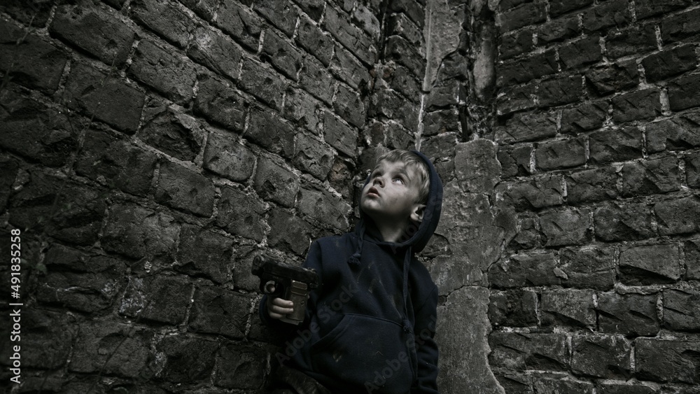 Child playing war in ruins Child playing war in ruins