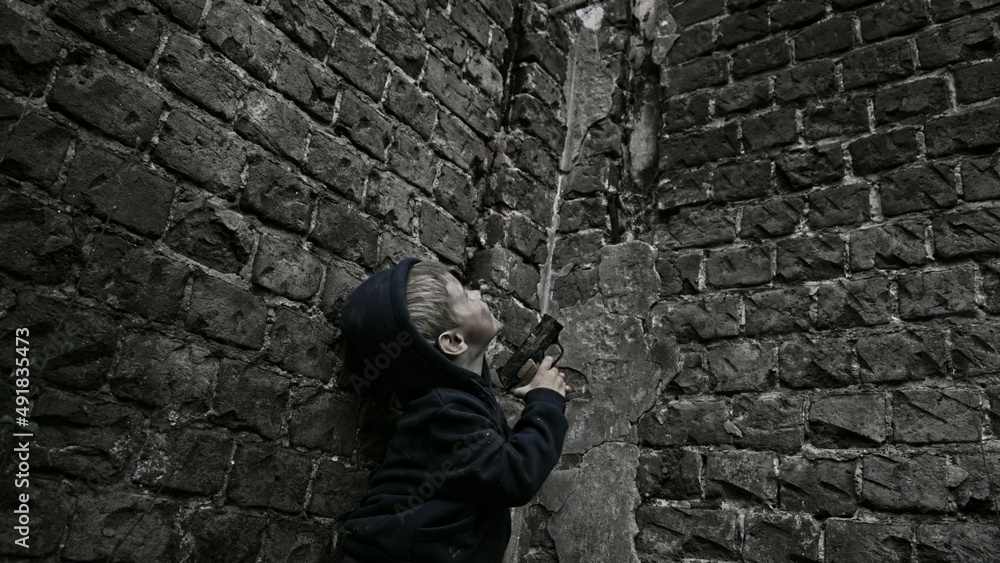 Child playing war in ruins Child playing war in ruins