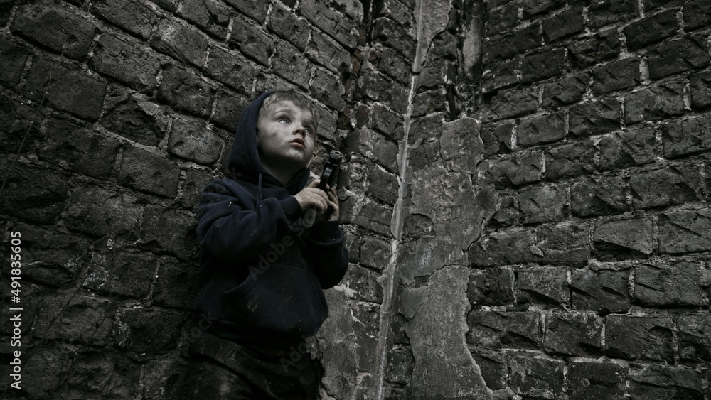 Child playing war in ruins