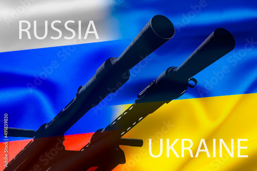 Military conflict between Russia and Ukraine, A gun against the background of two state flags of the warring states.