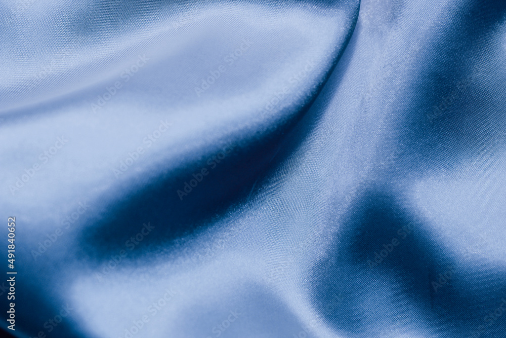 Purple shiny silk satin background in waves. Purple shiny silk satin background in waves.