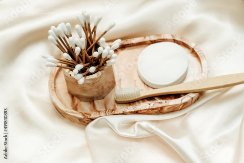 Gypsum marble decorative stand with cosmetic sticks and sponges and cotton.