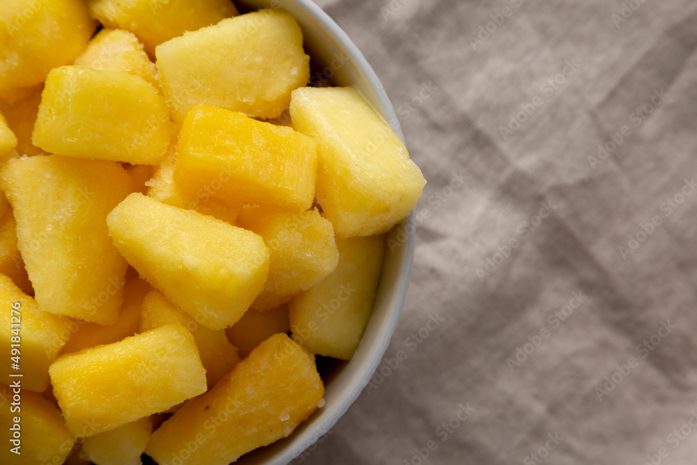 Organic Frozen Pineapple Slices in a Bowl, top view. Flat lay, overhead, from above. Copy space. Organic Frozen Pineapple Slices in a Bowl, top view. Flat lay, overhead, from above. Copy space.
