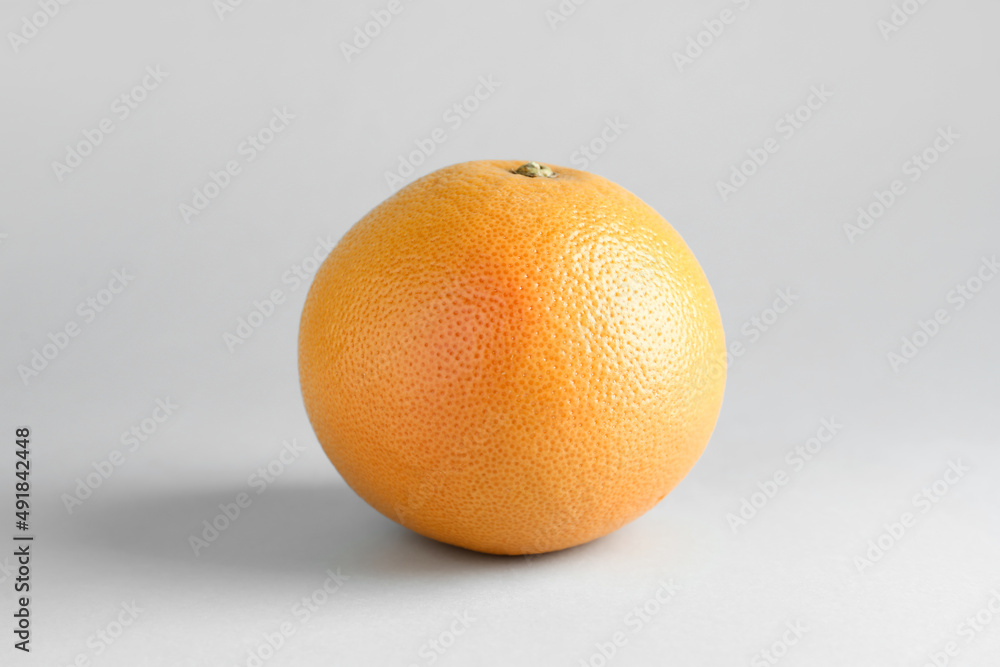 Tasty ripe grapefruit on light background Tasty ripe grapefruit on light background