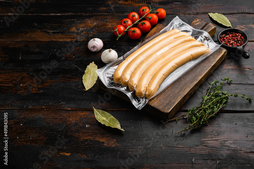 Packing sausages, on old dark  wooden table background, with copy space for text