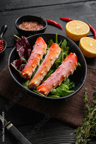 Snow crab legs, on black wooden table background