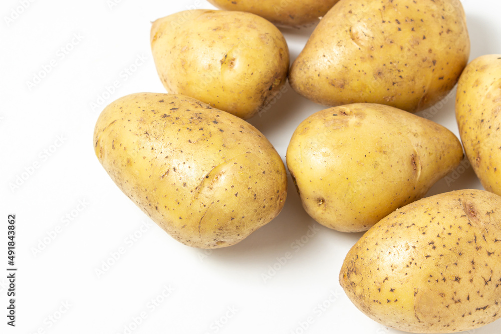 Young potatoes on a white background. Raw yellow potatoes. New crop Young potatoes on a white background. Raw yellow potatoes. New crop
