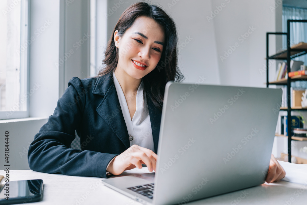 Young Asian businesswoman working at office Young Asian businesswoman working at office