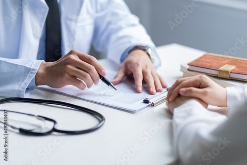 Asian male doctor examining patient at clinic