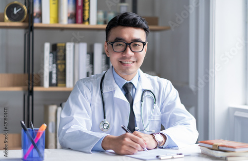 Image of young Asian doctor working at clinic