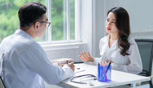 Asian male doctor examining patient at clinic