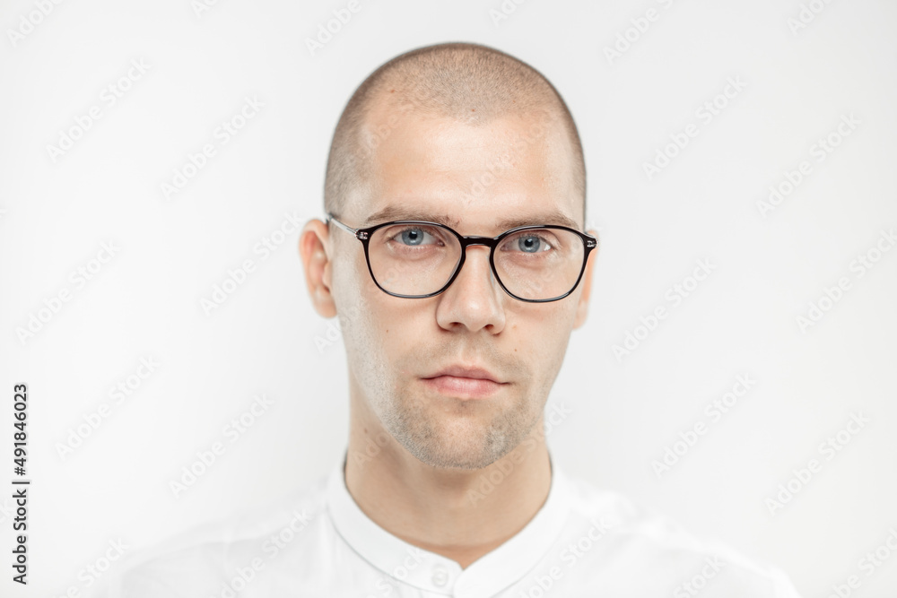 A handsome businessman with glasses on a light background A handsome businessman with glasses on a light background