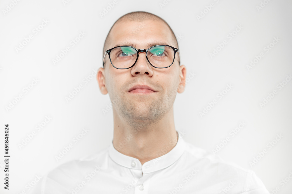 A handsome businessman with glasses on a light background A handsome businessman with glasses on a light background