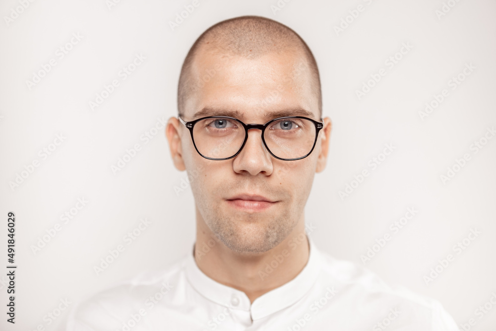 A handsome businessman with glasses on a light background
