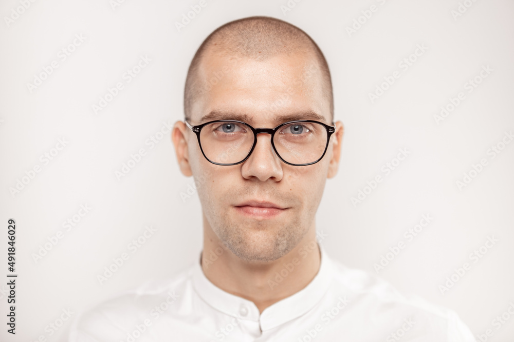 A handsome businessman with glasses on a light background A handsome businessman with glasses on a light background