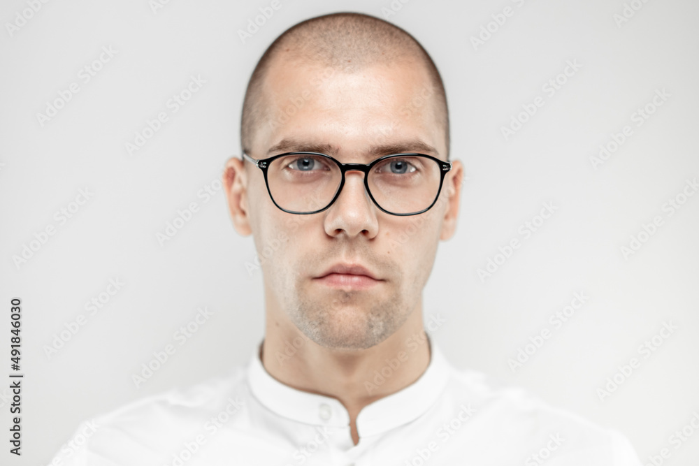 A handsome businessman with glasses on a light background A handsome businessman with glasses on a light background