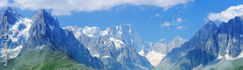 high mountains, rocky cliffs with trees, in the background you can see the French Alps with the snow-capped Mont Blanc, the concept of hiking, rock climbing, active lifestyle, beauty of nature © kittyfly