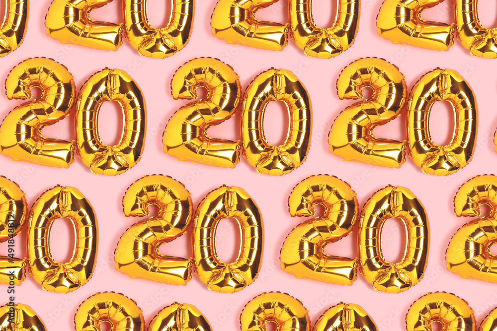 Numbers 20 golden balloons pattern. Twenty years anniversary celebration concept on a pink background. Numbers 20 golden balloons pattern. Twenty years anniversary celebration concept on a pink background.