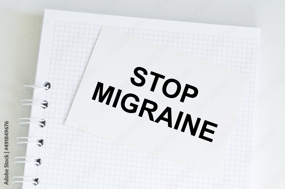 Text on a card Stop Migraine, medical concept. Text on a card Stop Migraine, medical concept.