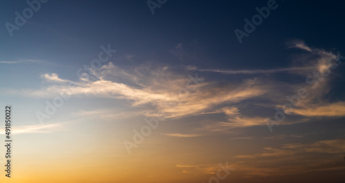 Fototapeta Naklejka Na Ścianę i Meble -  sunset sky in the evening with orange sunlight clouds on dark blue, dusk sky background 