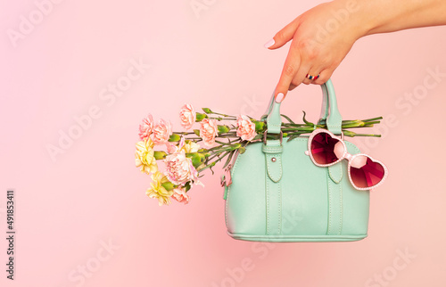 Photography Fashion spring accessories - mint handbag (purse) and heart shaped sunglasses on pastel pink