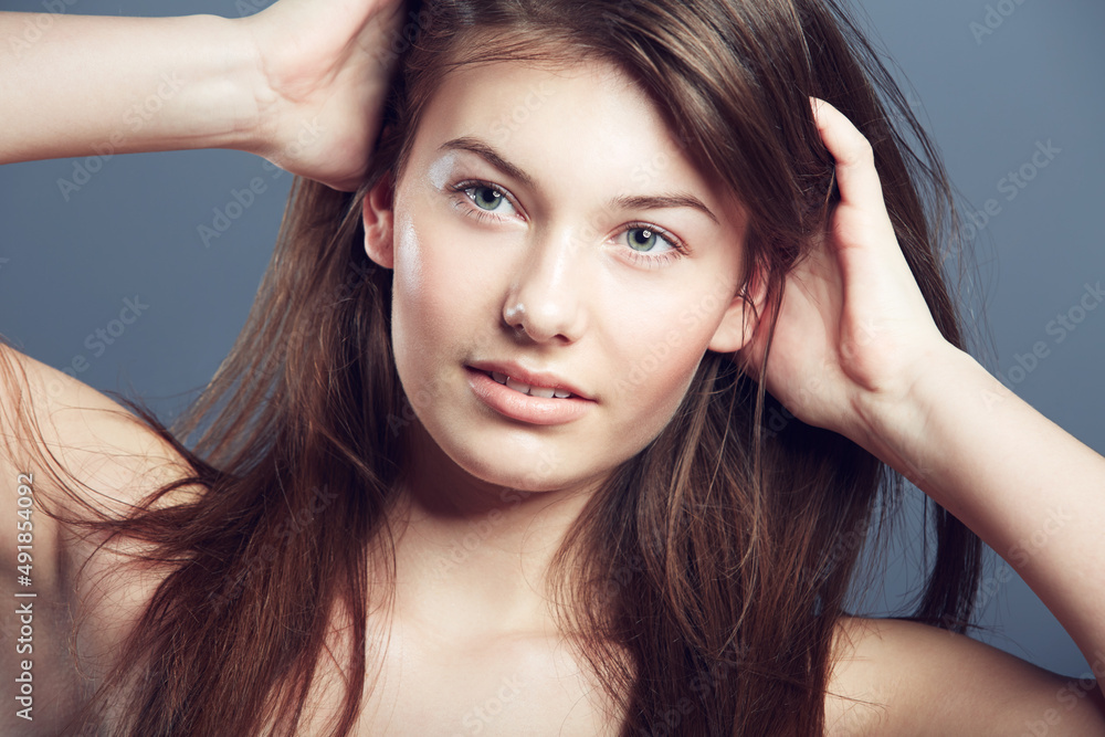 Showing off her luscious locks. Beauty shot of a young woman. Showing off her luscious locks. Beauty shot of a young woman.
