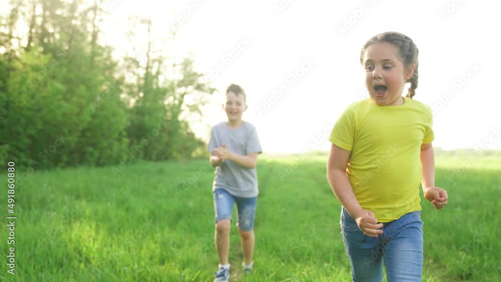 catch-up. children kid dream together run in the park at sunset. happy family people in park concept. boy and girl playing run. baby child fun running in green meadow. happy family kid dream concept