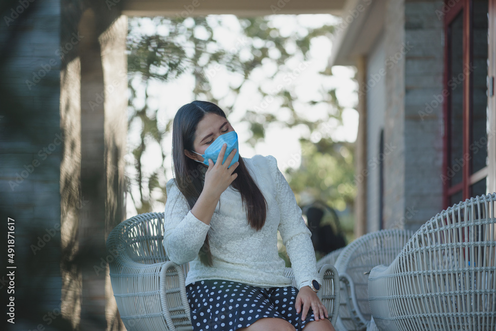 Fototapeta premium Young Asian woman wearing protection face mask prevent Corona Virus Disease (Covid-19). Infection and Pandemic concept