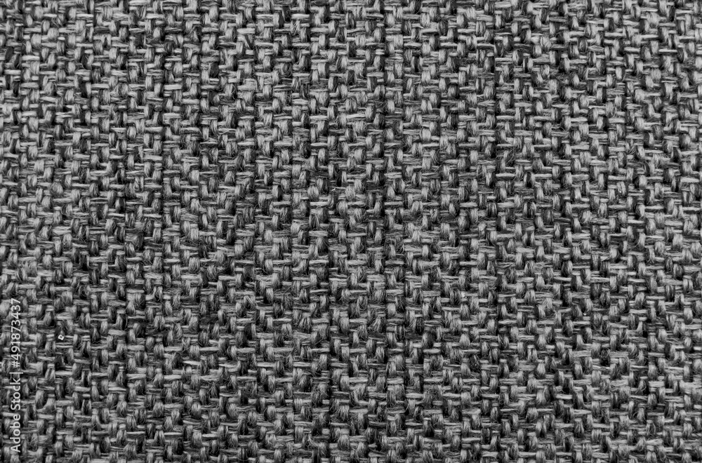 The fabric is dense gray with straight geometric lines and stitching. Dark color material for furniture upholstery, tailoring The fabric is dense gray with straight geometric lines and stitching. Dark color material for furniture upholstery, tailoring