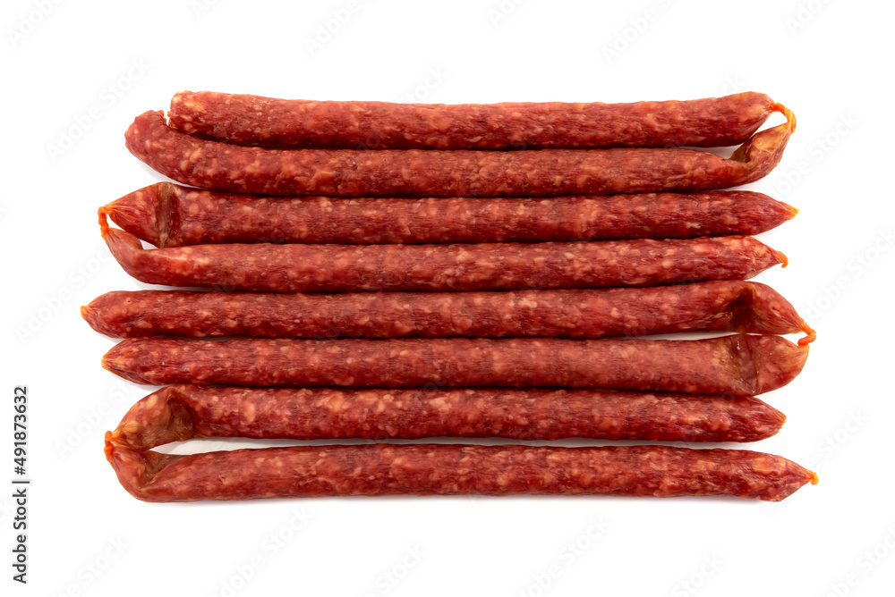 Thin dry sausages or sausages on a white background. Sausages isolate Thin dry sausages or sausages on a white background. Sausages isolate