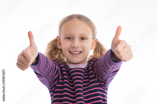 Successful young girl looking into camera for a thumbs up