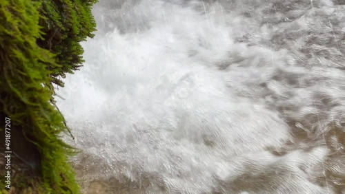 Waterfall water falling and hitting the water surface in the forest photo