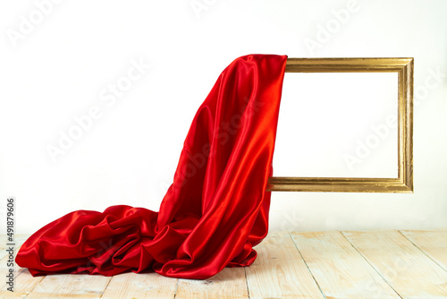 Принти на полотні red satin cloth unveiling a golden frame