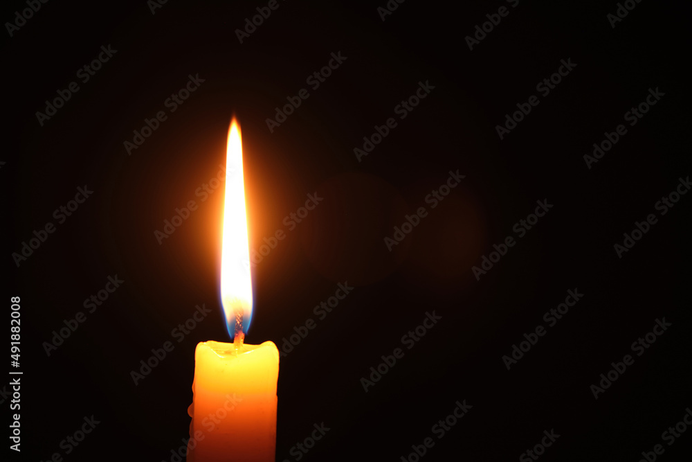 Flame burning candle black background.Concept memory and sorrow. Flame burning candle black background.Concept memory and sorrow.