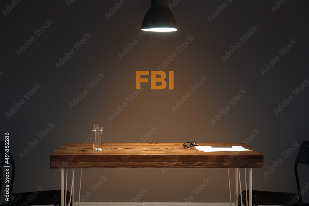 Table in dark interrogation room - obrazy, fototapety, plakaty 