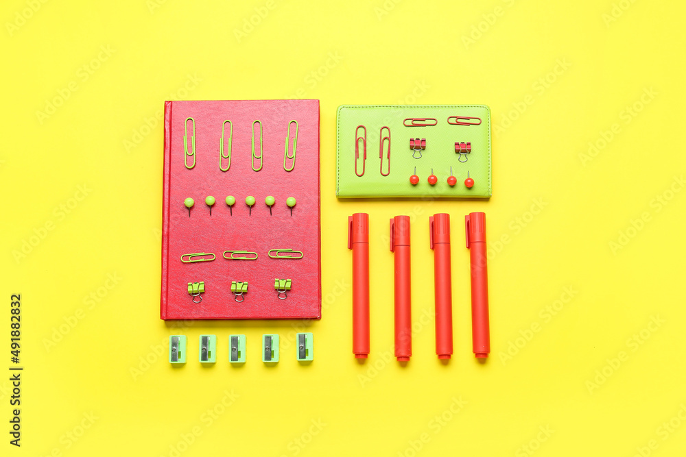 Composition with different stationery on yellow background Composition with different stationery on yellow background