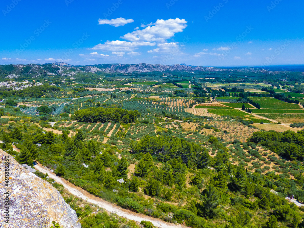Magnificent landscape with a view of the fields, nature and the Alpilles from the heights of Baux de Provence in Provence in France 