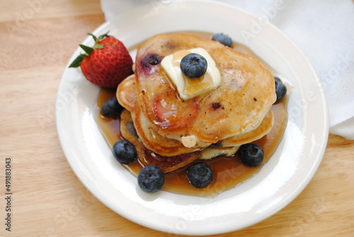Healthy Strawberry and Blueberry Pancakes Served with Syrup	