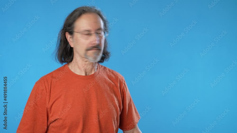 Surprised joyful mature man hold mobile cell phone typing say wow success points to product sale, isolated on solid blue background studio copy space. Surprised joyful mature man hold mobile cell phone typing say wow success points to product sale, isolated on solid blue background studio copy space.