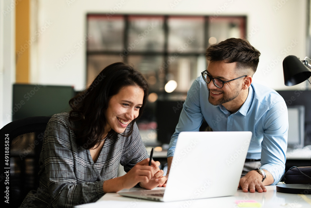 Colleagues in office. Businesswoman and businessman discussing work in office Colleagues in office. Businesswoman and businessman discussing work in office