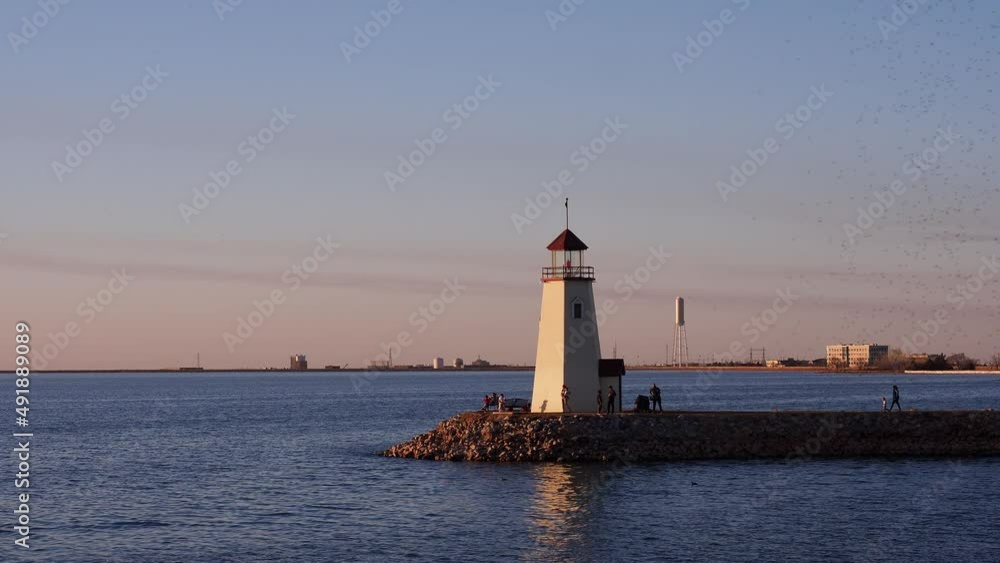 Sunset view of the lighthouse of Lake Hefner with flies flying around Sunset view of the lighthouse of Lake Hefner with flies flying around