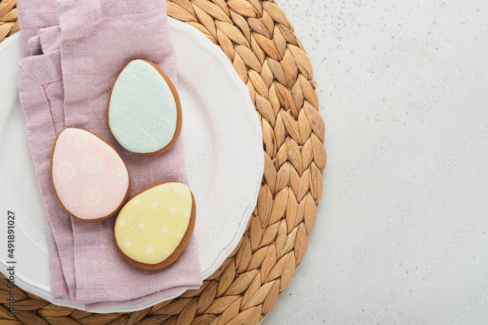 Easter table setting. Easter dinner with multicolored easter eggs. Elegance pastel and pink tablescapes. View from above. Christian religion tradition. Happy Easter concept. Mock up.