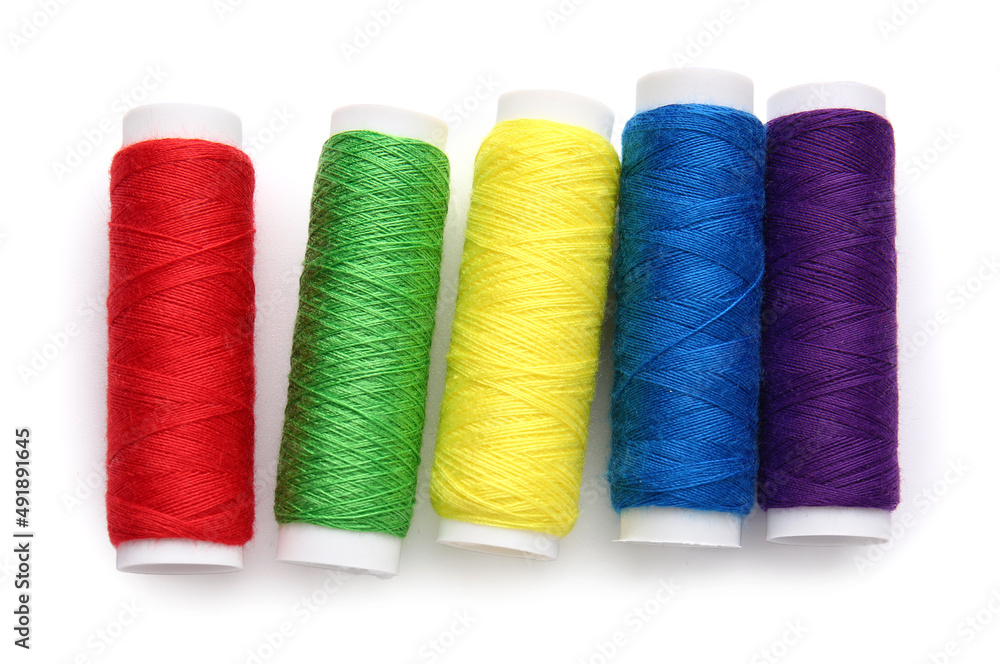 Different thread spools on white background Different thread spools on white background