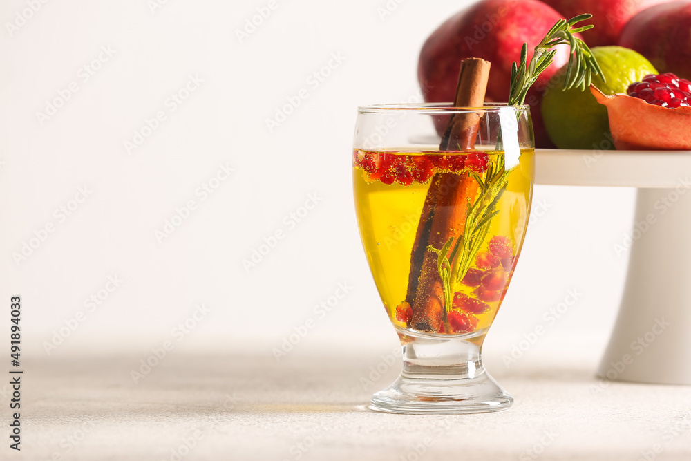 Glass of tasty pomegranate cocktail on white background Glass of tasty pomegranate cocktail on white background